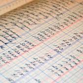 Detailed handwritten records on graph paper with blue and red lines.