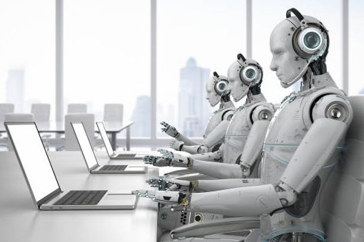 Three humanoid robots with headsets are working at computers in a modern office.